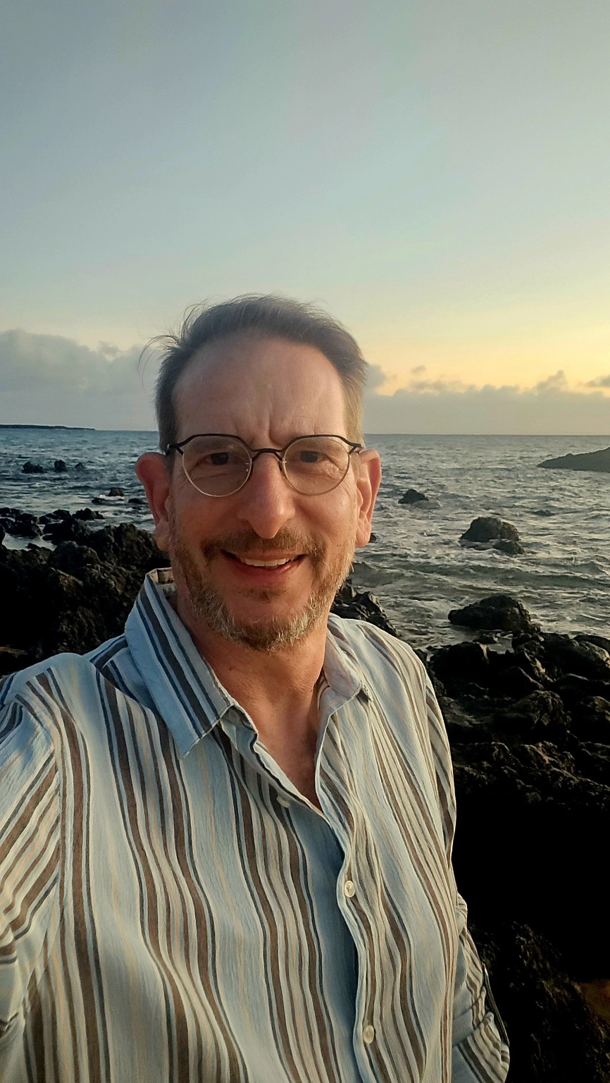 Benjamin Arazy by the ocean at sunset